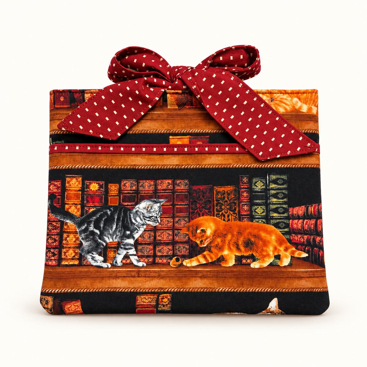 Handmade quilted book sleeve with front pocket and bow closure